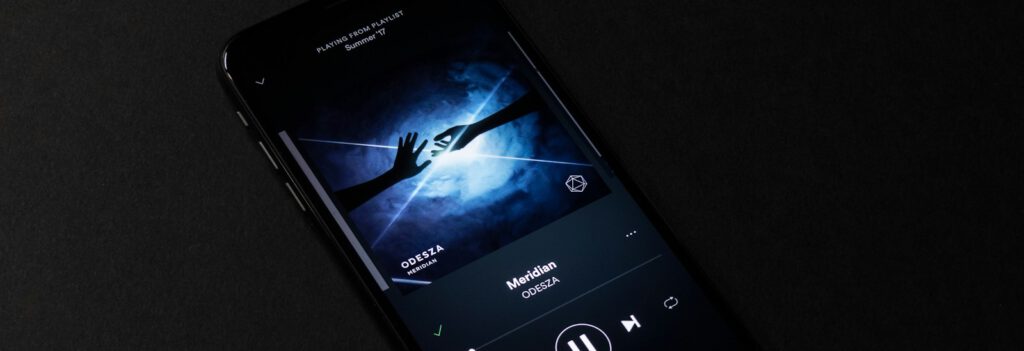 turned-on smartphone with music display