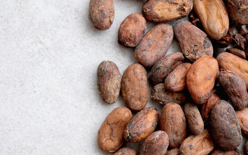 brown almond nuts on white surface